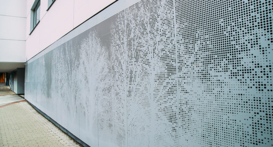 Abstract perforated grey metal panel. Trees pattern.